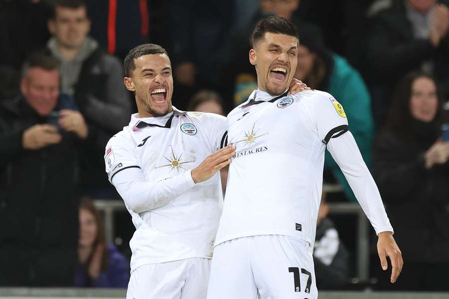 Joel Piroe of Swansea City, right, celebrates with Joel Latibeaudiere