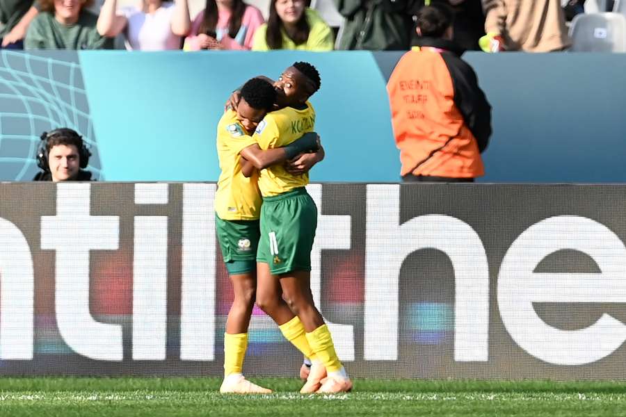 South Africa's forward #08 Hildah Magaia (L) hugs South Africa's forward #11 Thembi Kgatlana after scoring her team's second goal