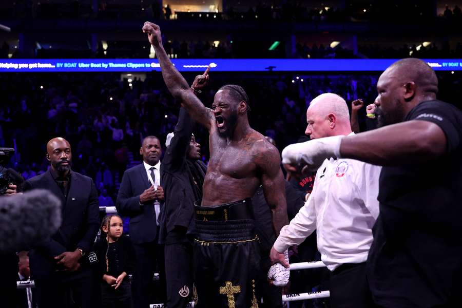 Deontay Wilder celebrates after beating Derek Chisora in a wild bout at the O2 Arena