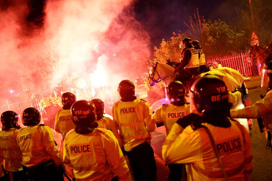 Fans van Legia Warschau steken fakkels af tijdens rellen met politieagenten buiten Villa Park