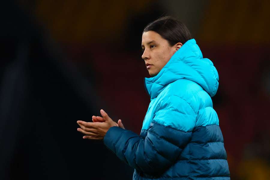 Injured Australia's captain Sam Kerr applauds the fans after her team's loss