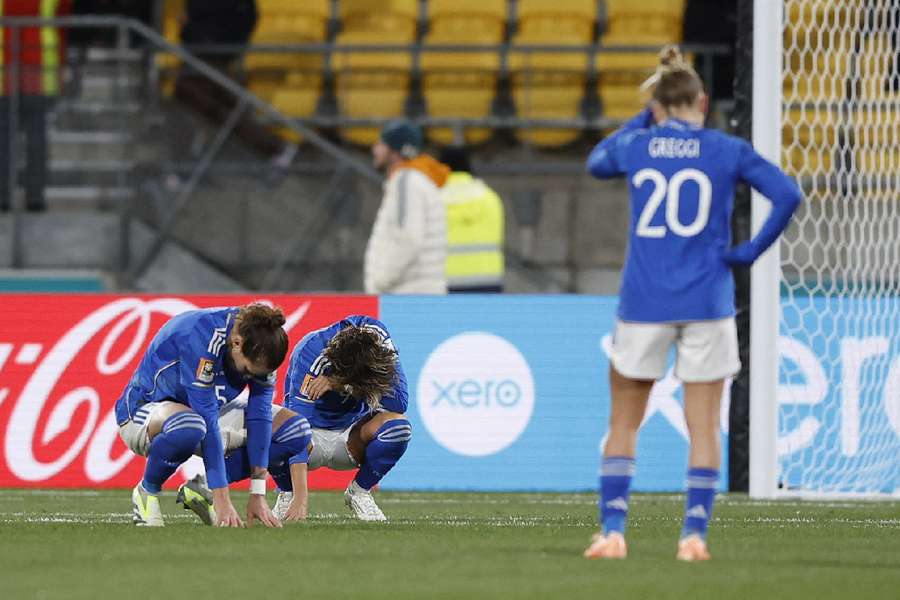 Italian players slump to the ground after their exit from the Women's World Cup 