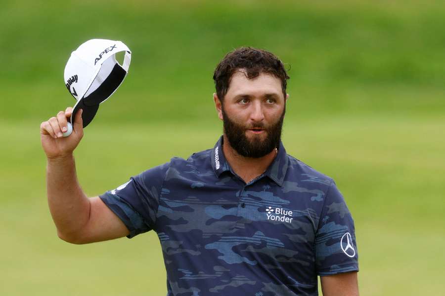 Jon Rahm acknowledges the spectators on the 18th green after finishing his third round