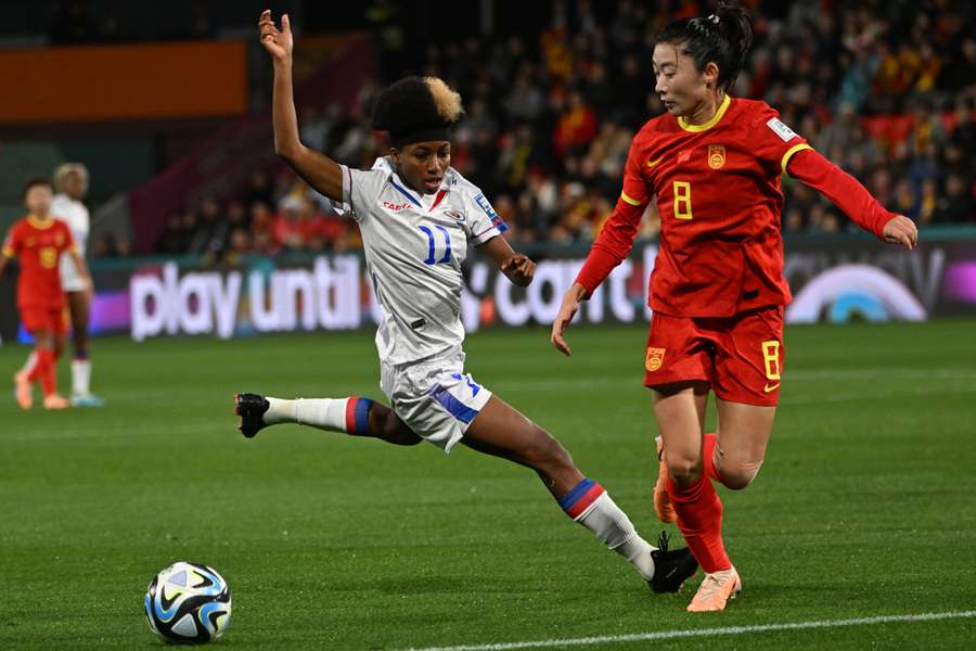 Haiti's Roseline Eloissaint and China's Yao Wei vie for the ball