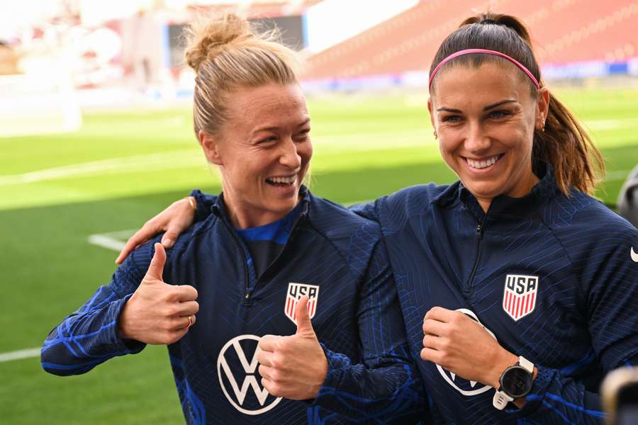 USA players Emily Sonnett (L) and Alex Morgan before starting training