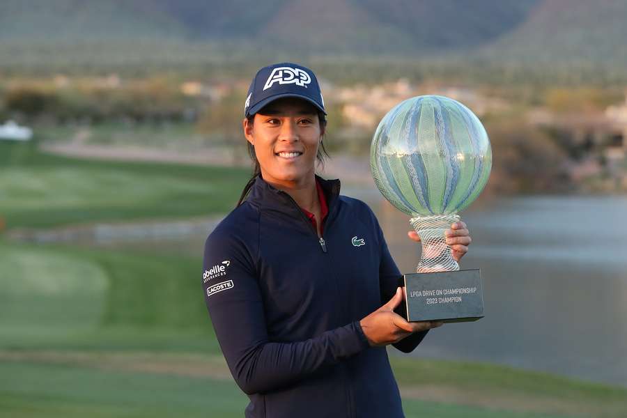 Boutier poses with the trophy after her dramatic victory