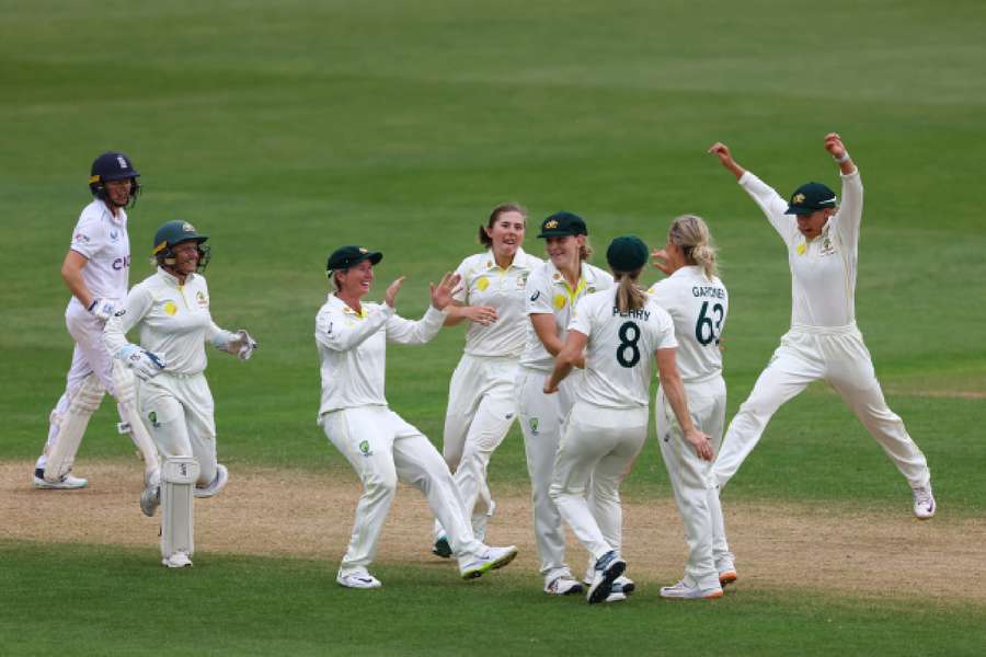 Australia's Ashleigh Gardner celebrates with teammates after bowling out England's Heather Knight