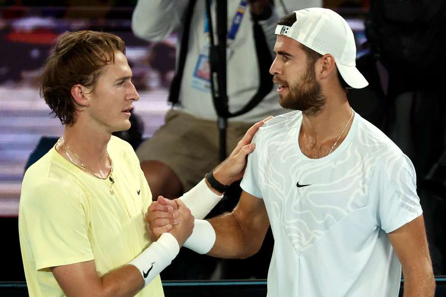 Russia's Karen Khachanov (R) embraces American Sebastian Korda