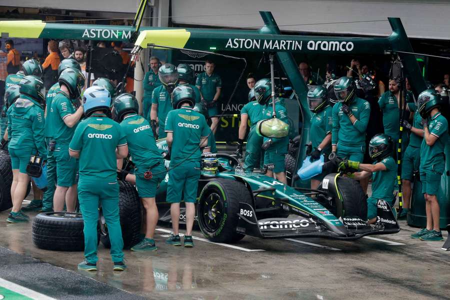 Mechanics work on the car of Aston Martin's Fernando Alonso during qualifying in Sao Paulo