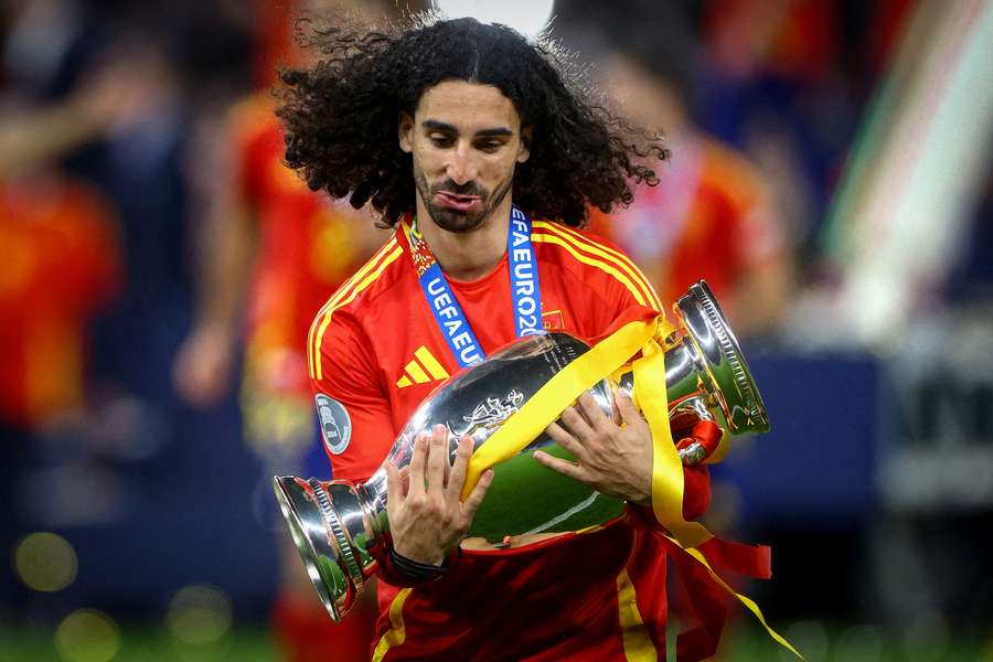 Spain's Marc Cucurella celebrates with the trophy after winning the final