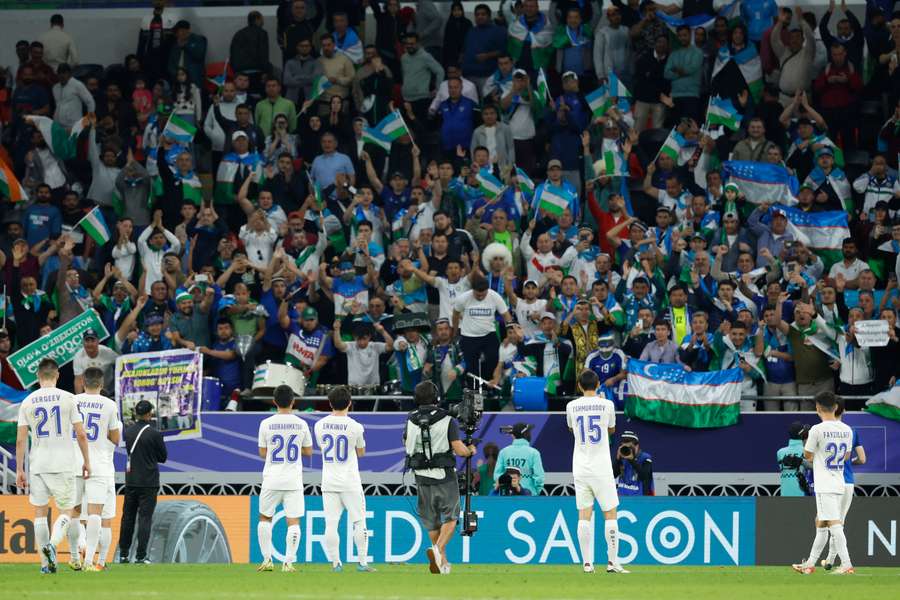 Uzbekistan's players celebrate in front of their fans