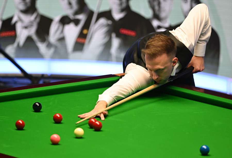 England's Judd Trump plays a shot during the Masters snooker tournament final 