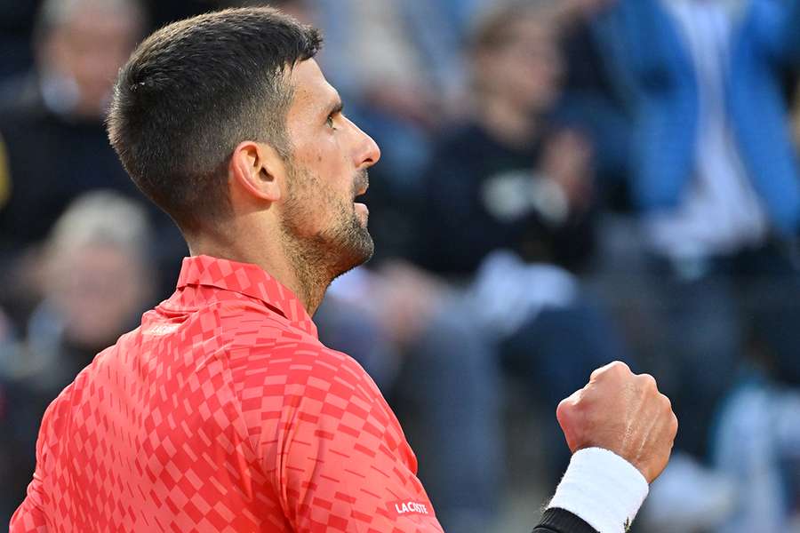 Serbia's Novak Djokovic celebrates winning a point against Argentina's Tomas Etcheverry