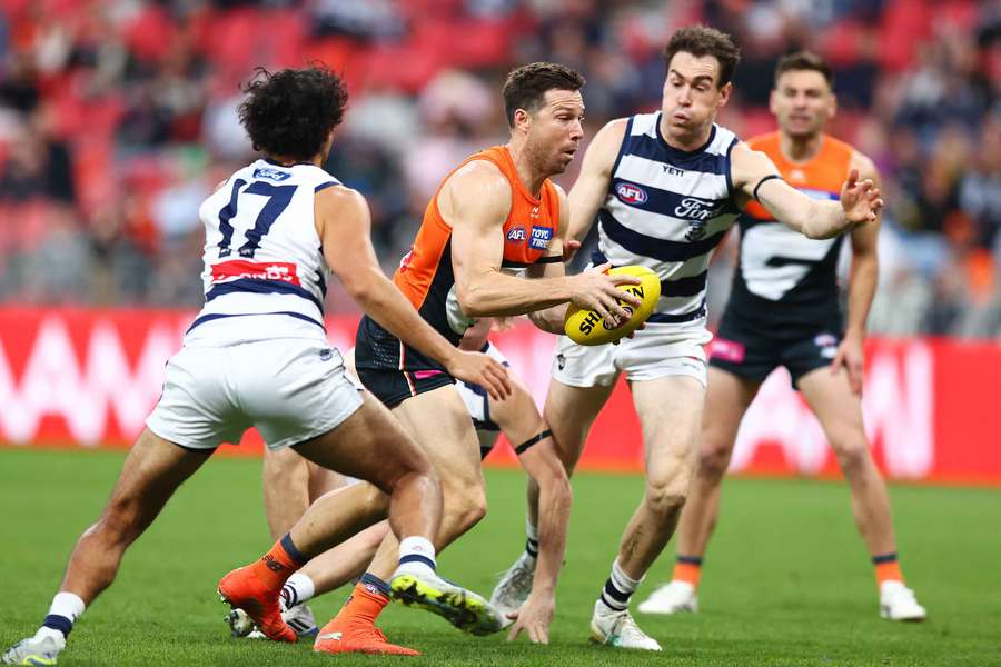 Toby Greene attempts to evade a tackle from future teammate Jeremy Cameron. Toby Greene attempts to evade a tackle from future teammate Jeremy Cameron.