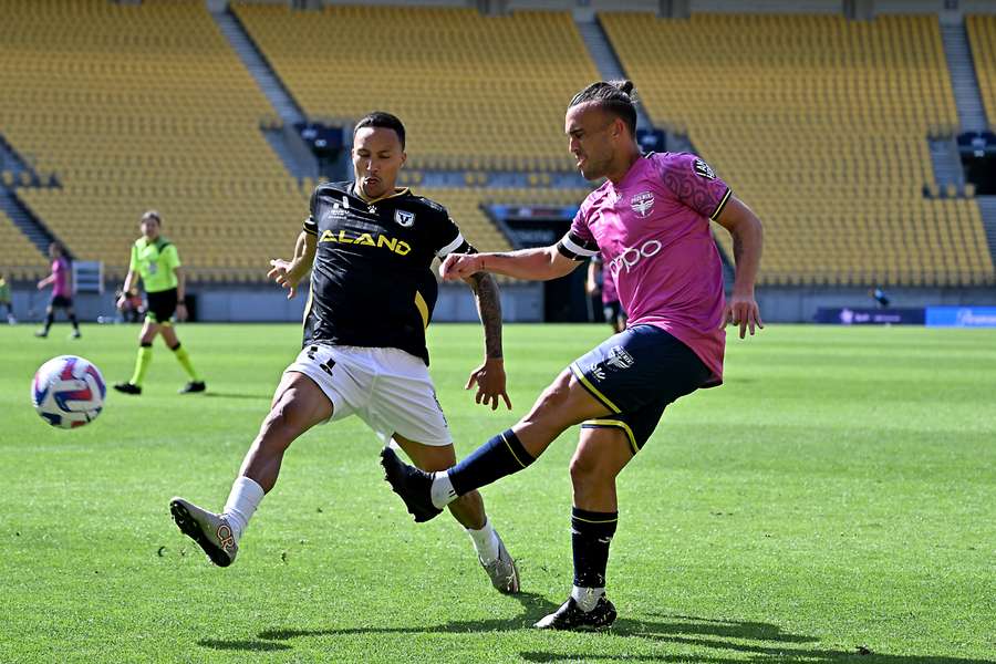 Kearyn Baccus and Clayton Lewis compete for the ball as former opponents. 