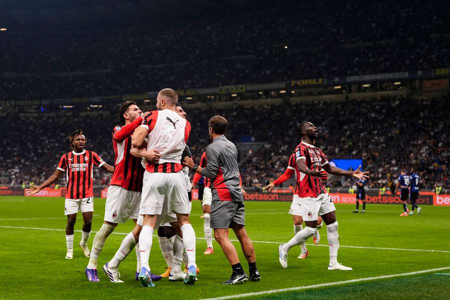 AC Milan celebrate their late winner in the derby