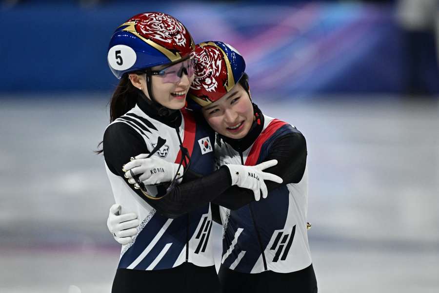 South Korea's Kim Gil-li (#5) embraces South Korea's Choi Min-jeong after winning gold in the women's 1500m