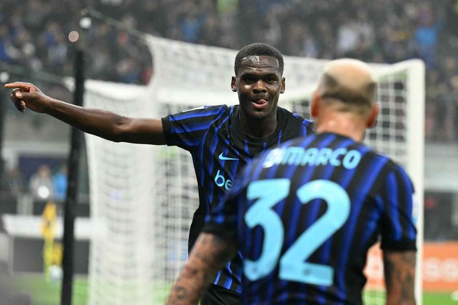 Inter Milan's French forward #14 Ange-Yoan Bonny (L) celebrates with defender #32 Federico Dimarco