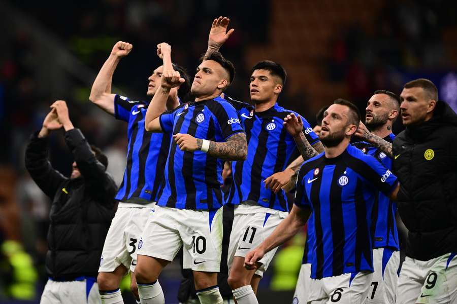 Inter players celebrate in front of their fans after their victory over AC Milan