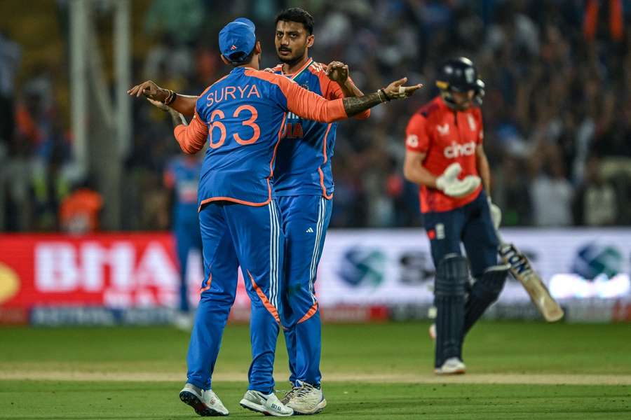 India's Axar Patel celebrates with his captain Suryakumar Yadav after taking the wicket of England's Phil Salt