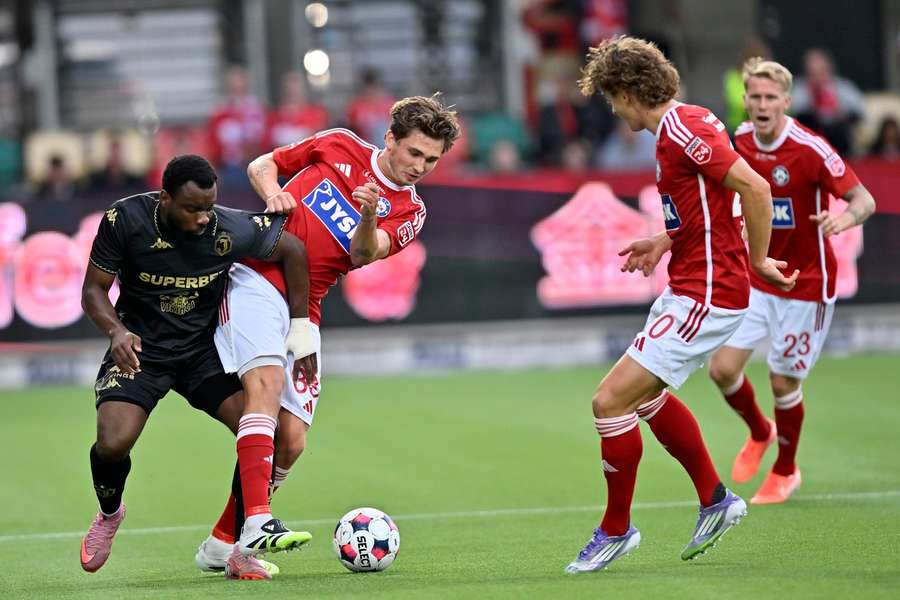 Silkeborg's Mads Freundlich and Jagiellonia Bialystok's Afimico Pululu in action during the game