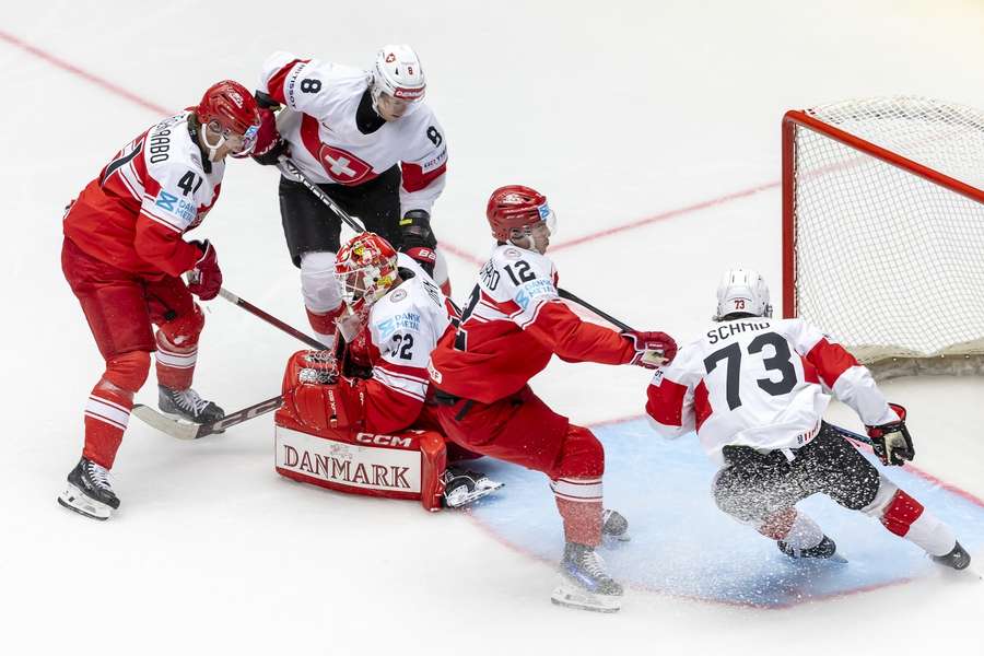 Denmark's goaltender Sebastian Dahm (C) and Jesper Jensen Aabo (L) in action against Switzerland's (2-L) Simon Knak Denmark's goaltender Sebastian Dahm (C) and Jesper Jensen Aabo (L) in action against Switzerland's (2-L) Simon Knak