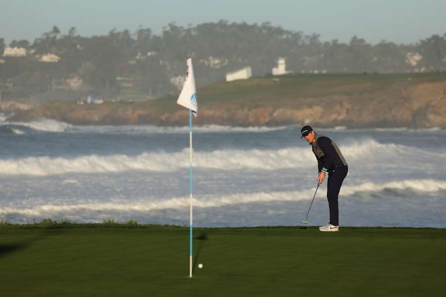 Justin Rose of England reacts to his putt on the 10th green 