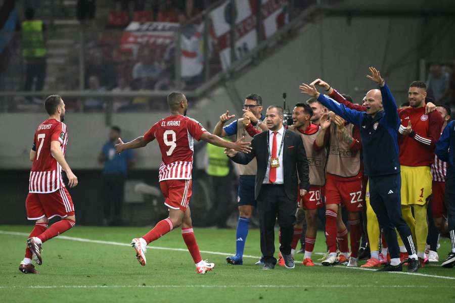 Moroccan striker #09 Ayoub el-Kaabi (2L) runs to celebrate with teammates after scoring Olympiacos' second goal