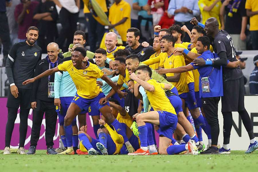 Al-Gharafa's players celebrate their win over Al Ain