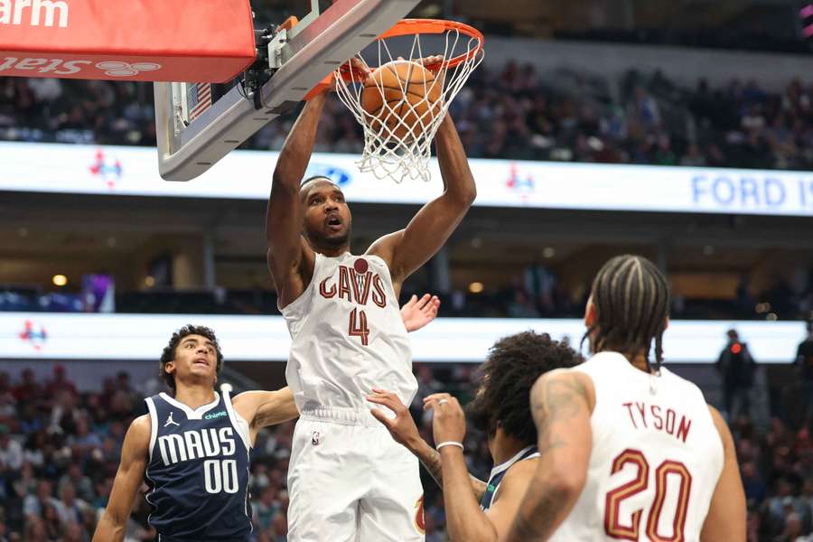 Il centro dei Cleveland Cavaliers Evan Mobley schiaccia davanti alla guardia dei Dallas Mavericks Max Christie