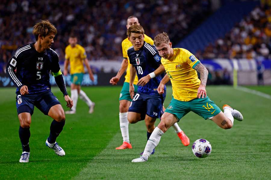 Australia's Riley McGree in action with Japan's Ritsu Doan and Hidemasa Morita