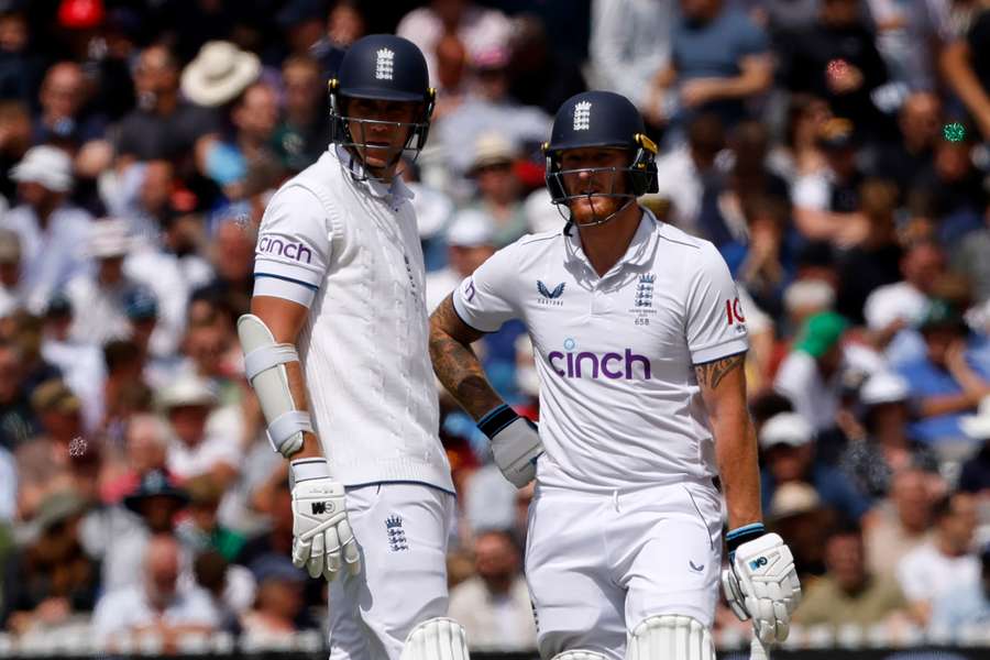 England's Stuart Broad (L) and Ben Stokes (R) chat on day five of the second Ashes Test