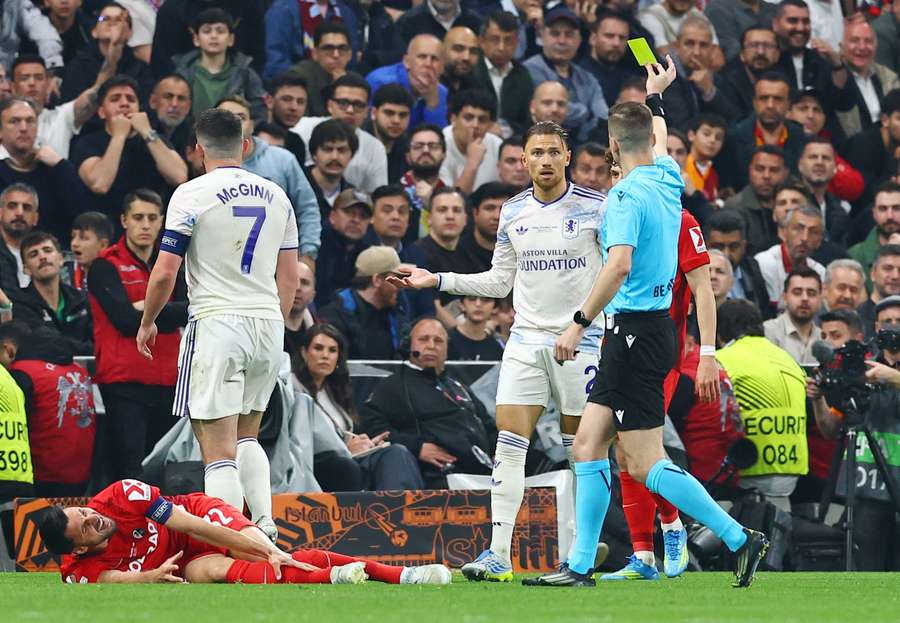 Matty Cash is shown a yellow card