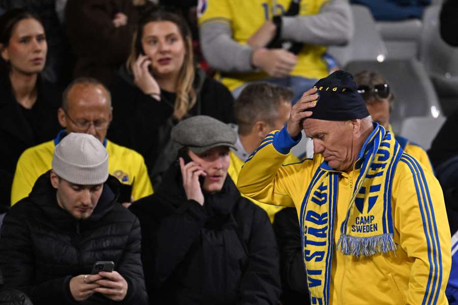 Swedish supporters react as they wait in the stand during the Euro 2024 qualifying football match between Belgium and Sweden