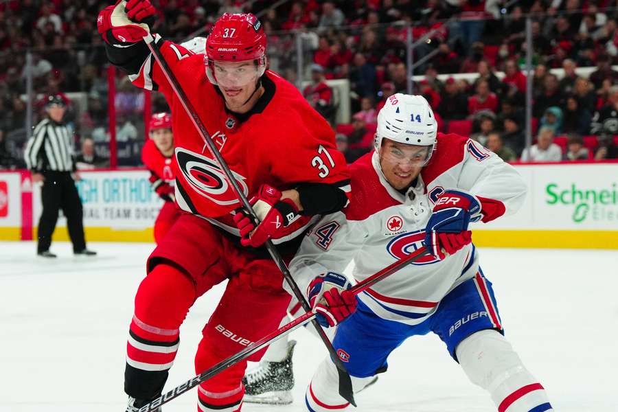 Carolina's Andrei Svechnikov battling for possesion with Canadiens Nick Suzuki