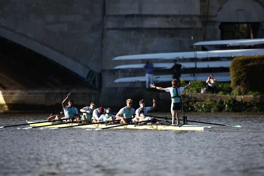 Cambridge celebrate their defeat of Oxford in the 169th men's university Boat Race on London's River Thames