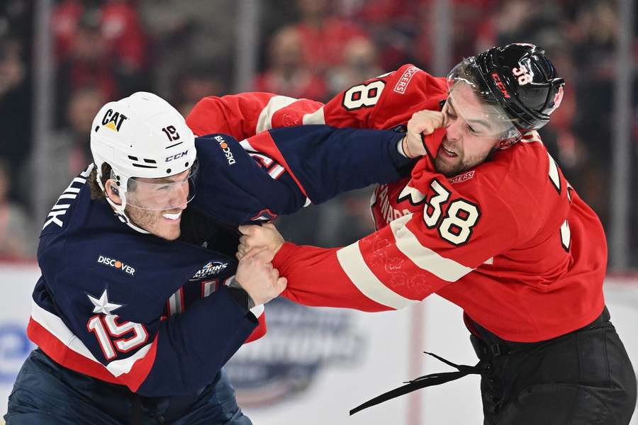 USA's Matthew Tkachuk fights with Canada's Brandon Hagel during the 4 Nations Face-Off game