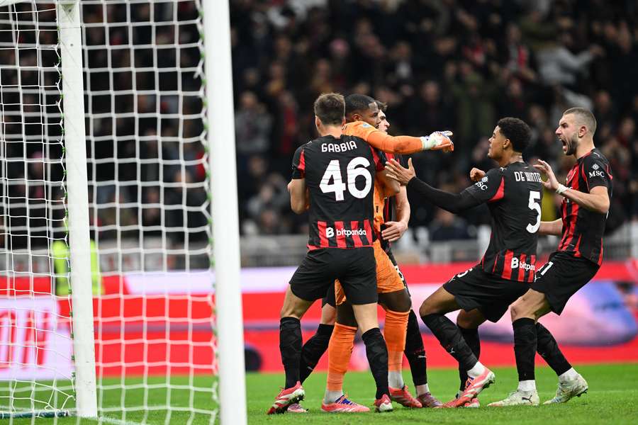 Maignan po zlikvidovanej penalte v obkľúčení spoluhráčov.