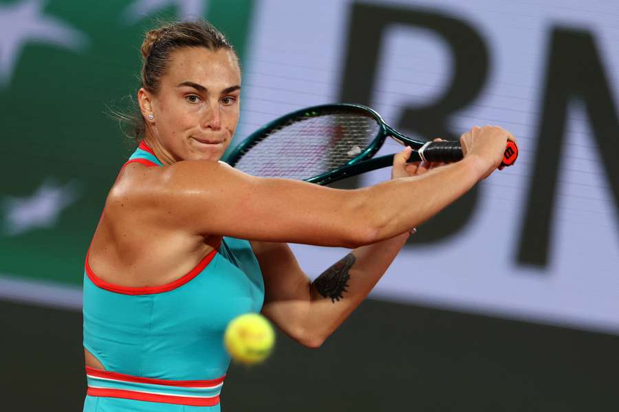 Aryna Sabalenka plays a backhand return to Kamilla Rakhimova