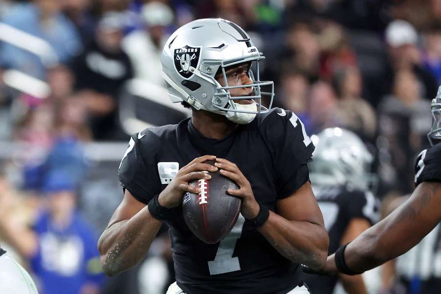 Geno Smith steps back for a pass 