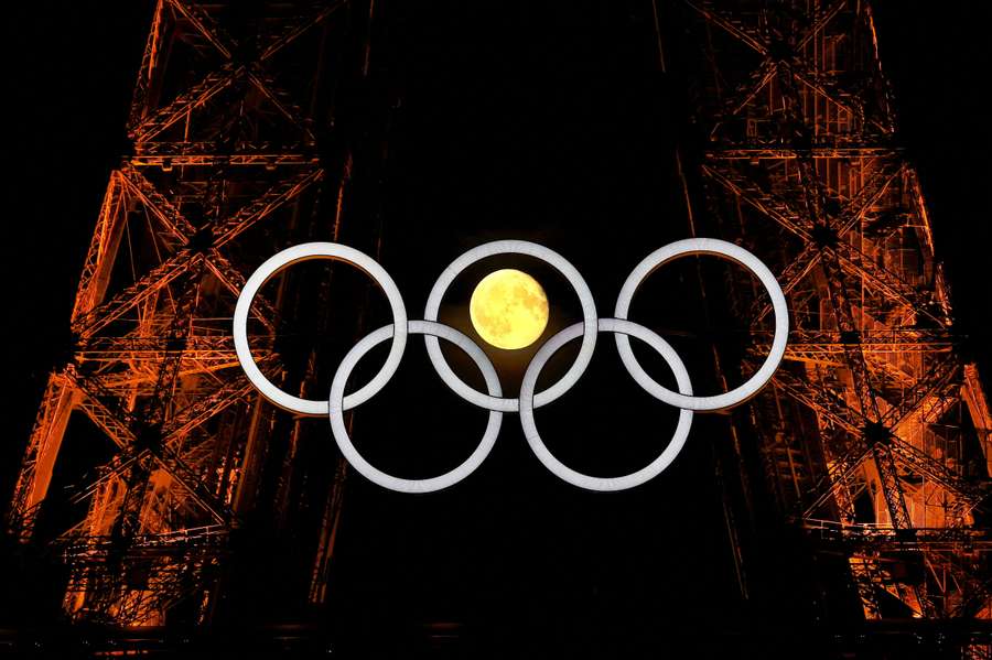 The moon is pictured with the Olympic rings on the Eiffel Tower ahead of the Paris 2024 Olympic and Paralympic Games