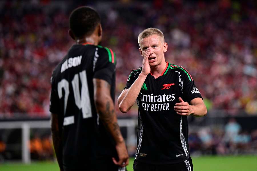 Arsenal's Oleksandr Zinchenko, right, talks to Reiss Nelson (24) during a friendly 