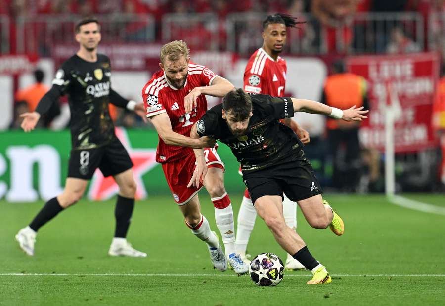Bayern Munich's Konrad Laimer in action with Paris St Germain's Khvicha Kvaratskhelia