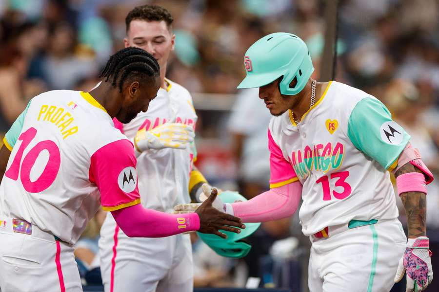 Manny Machado celebrates with Jurickson Profar, right