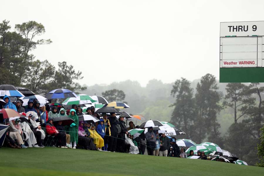 Patrons watch play on the 18th green