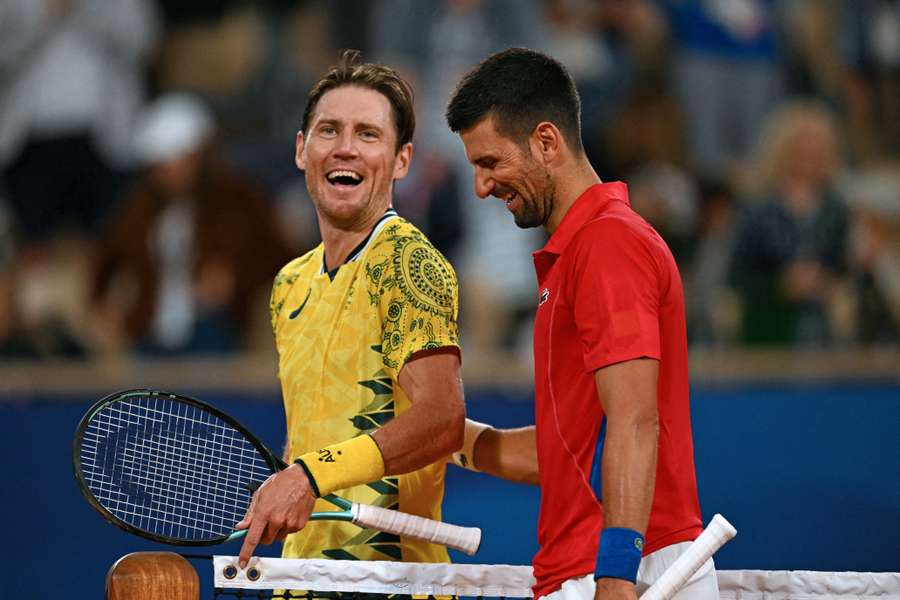 Serbia's Novak Djokovic (R) shares a joke with Australia's Matthew Ebden (L)