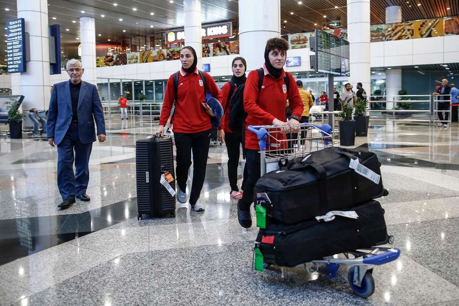 Iran's women's football team head through transit in Kuala Lumpur. Iran's women's football team head through transit in Kuala Lumpur.