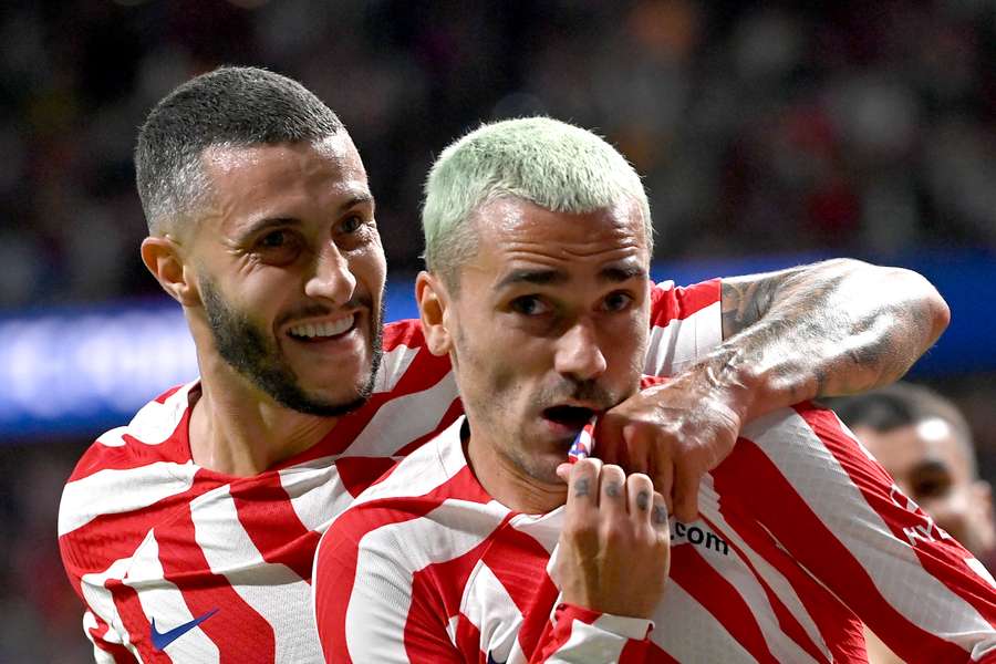 Antoine Griezmann (R) celebrates with Mario Hermoso after scoring against Porto.