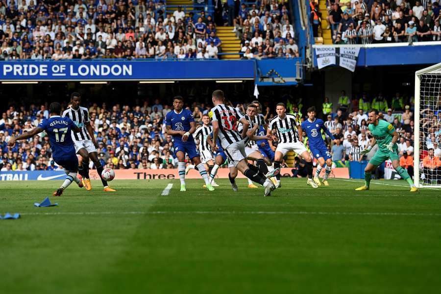 Chelsea's English midfielder Raheem Sterling (L) shoots the ball leading to the own goal that Newcastle United's English defender Kieran Trippier puts in