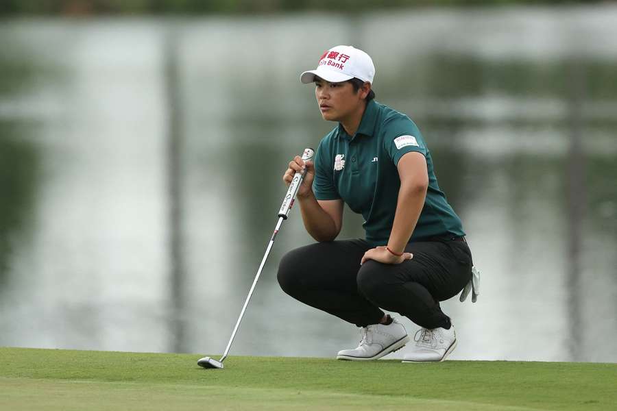 Peiyun Chien of Chinese Taipei lines up a putt on the ninth hole during the first round